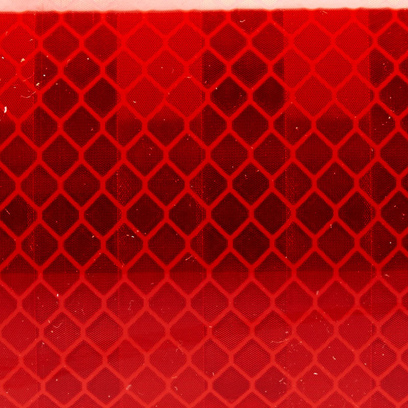 Close-up of red 3M Diamond Series Reflective Tape - Safety through visibility.