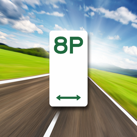 A green 'P' shaped parking sign with a directional arrow, set against a blurred background of a road.